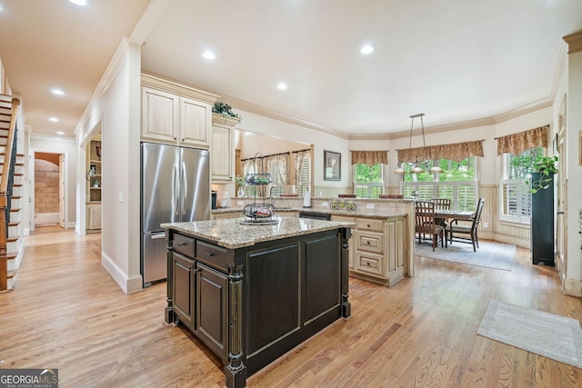 kitchen with a kitchen island, stainless steel fridge, ornamental molding, and light wood-type flooring