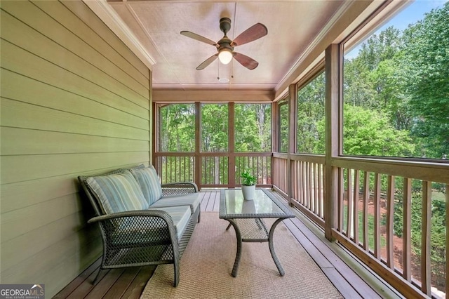 sunroom featuring ceiling fan