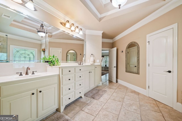 bathroom with vanity, a tray ceiling, visible vents, ornamental molding, and stone tile flooring