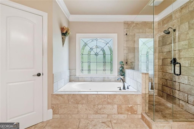 bathroom featuring crown molding, a shower stall, and a garden tub