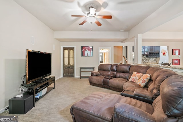 living room with visible vents, baseboards, ceiling fan, and light carpet
