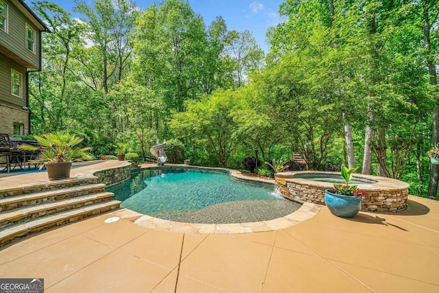view of pool with a water slide, a pool with connected hot tub, and a patio