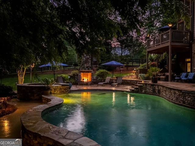 pool with a patio area and fence