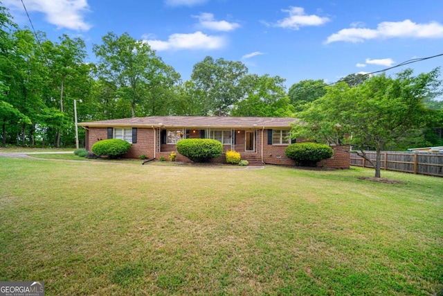 110 Otelia Ln, Covington, GA 30014 - ranch-style house featuring brick siding, fence, and a front yard