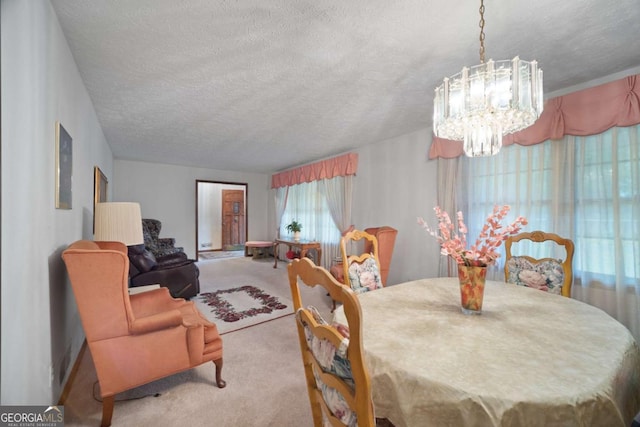 110 Otelia Ln, Covington, GA 30014 - carpeted dining space featuring a textured ceiling and an inviting chandelier