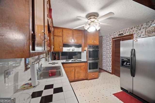 110 Otelia Ln, Covington, GA 30014 - kitchen featuring a sink, stainless steel appliances, a ceiling fan, tile countertops, and wallpapered walls