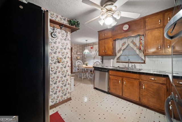 110 Otelia Ln, Covington, GA 30014 - kitchen featuring brown cabinets, appliances with stainless steel finishes, and a sink