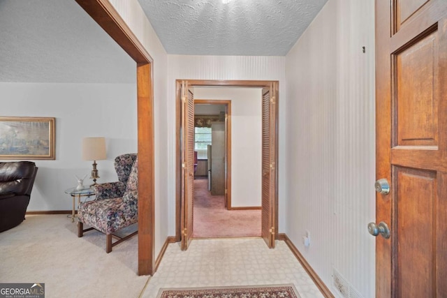 110 Otelia Ln, Covington, GA 30014 - corridor featuring baseboards, light carpet, and a textured ceiling