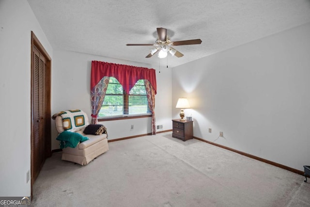 110 Otelia Ln, Covington, GA 30014 - living area featuring a textured ceiling, ceiling fan, carpet flooring, and baseboards