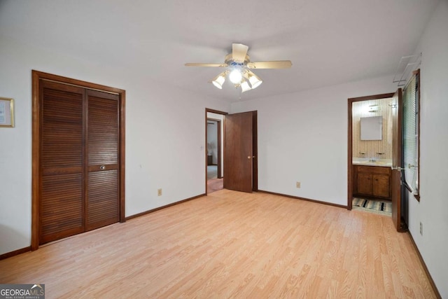 110 Otelia Ln, Covington, GA 30014 - unfurnished bedroom featuring baseboards, light wood-style flooring, and a closet
