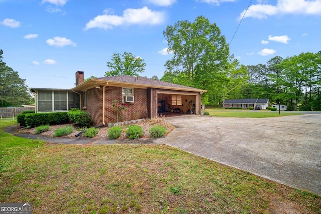 110 Otelia Ln, Covington, GA 30014 - view of front facade with a front lawn, a garage, a chimney, driveway, and brick siding