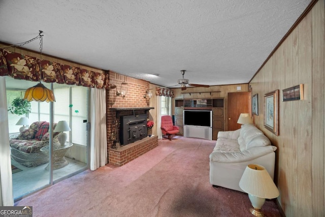 110 Otelia Ln, Covington, GA 30014 - living room with a textured ceiling, wooden walls, a ceiling fan, and carpet flooring