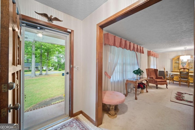 110 Otelia Ln, Covington, GA 30014 - carpeted entryway featuring a textured ceiling, a chandelier, and baseboards