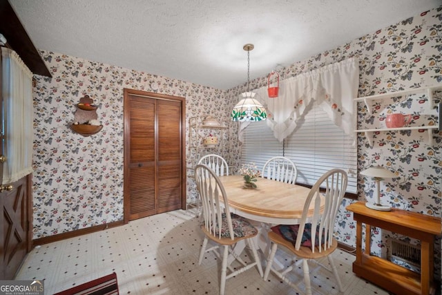110 Otelia Ln, Covington, GA 30014 - dining area with baseboards, wallpapered walls, and a textured ceiling