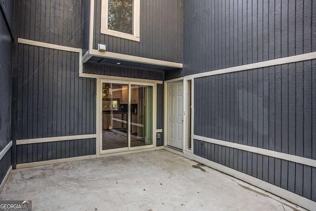 view of exterior entry featuring a patio area