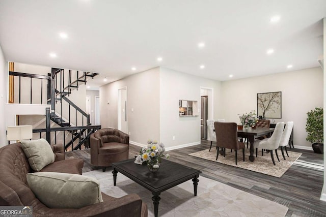living area with stairway, wood finished floors, recessed lighting, and baseboards
