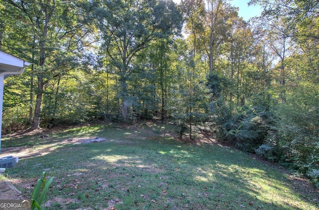 view of yard with a view of trees