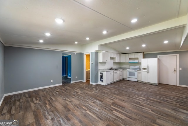 kitchen featuring baseboards, white appliances, a sink, dark wood-style floors, and open floor plan