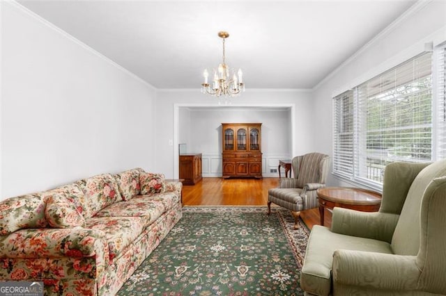 2558 Landeau Cir, Tucker, GA 30084 - living area with wood finished floors, a chandelier, and ornamental molding