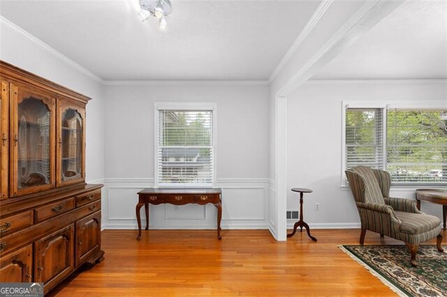 2558 Landeau Cir, Tucker, GA 30084 - living area featuring ornamental molding, light wood finished floors, and wainscoting