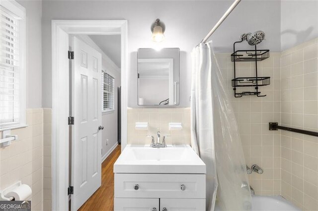 2558 Landeau Cir, Tucker, GA 30084 - full bath with shower / tub combo, vanity, wainscoting, and tile walls