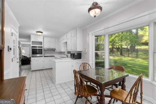 2558 Landeau Cir, Tucker, GA 30084 - kitchen with a sink, oven, light tile patterned flooring, ornamental molding, and a peninsula