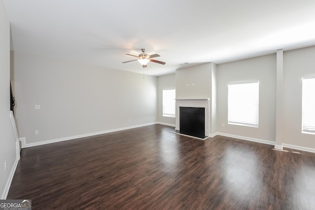 89 Citadel Dr, Hampton, GA 30228 - unfurnished living room with ceiling fan, baseboards, dark wood-style flooring, and a fireplace