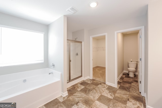 89 Citadel Dr, Hampton, GA 30228 - bathroom with stone finish flooring, a stall shower, toilet, a bath, and a spacious closet
