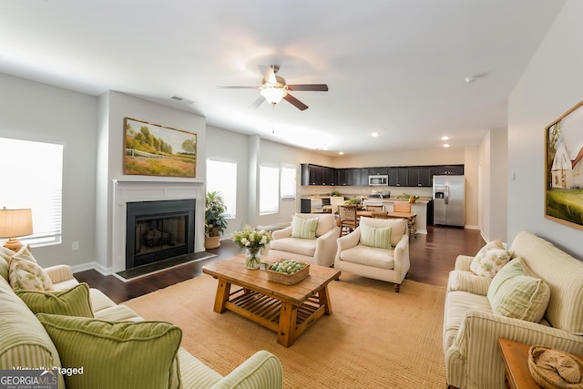 89 Citadel Dr, Hampton, GA 30228 - living area with recessed lighting, a glass covered fireplace, a ceiling fan, visible vents, and wood finished floors