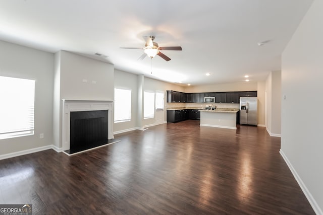 89 Citadel Dr, Hampton, GA 30228 - unfurnished living room featuring dark wood finished floors, recessed lighting, a fireplace, baseboards, and a ceiling fan
