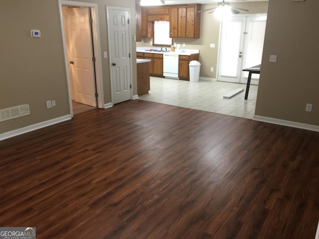 3875 Grand Prix St, Cumming, GA 30041 - unfurnished living room with dark wood-style floors, a sink, a ceiling fan, visible vents, and baseboards