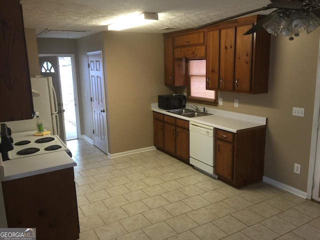 3875 Grand Prix St, Cumming, GA 30041 - kitchen featuring white appliances, light countertops, a sink, baseboards, and a ceiling fan