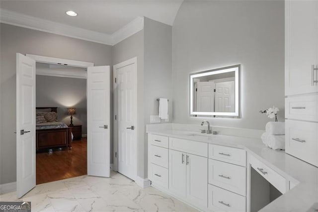 ensuite bathroom with ensuite bath, vanity, marble finish floor, baseboards, and ornamental molding