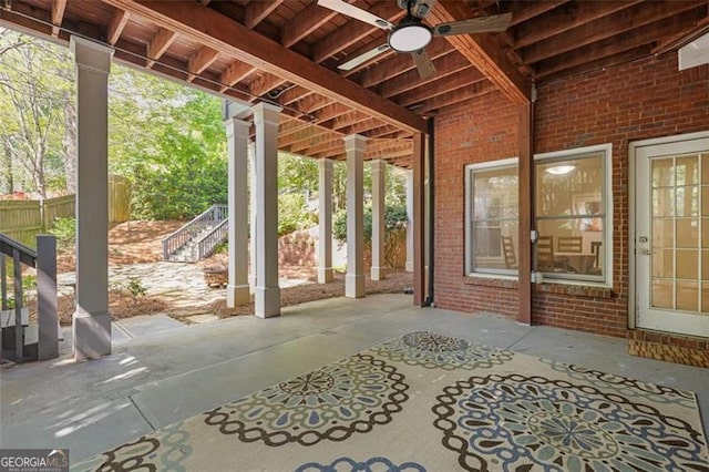 view of patio / terrace with stairs, ceiling fan, and fence