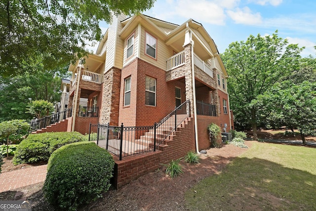 718 Province Pl SE, Atlanta, GA 30312 - view of side of home with a balcony, stairway, and brick siding