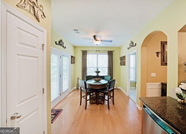 718 Province Pl SE, Atlanta, GA 30312 - dining area with arched walkways, light wood-style flooring, and baseboards