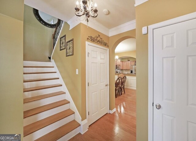 718 Province Pl SE, Atlanta, GA 30312 - stairs with arched walkways, a chandelier, wood finished floors, and crown molding