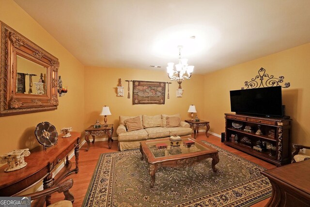 718 Province Pl SE, Atlanta, GA 30312 - living area featuring a chandelier, wood finished floors, and baseboards
