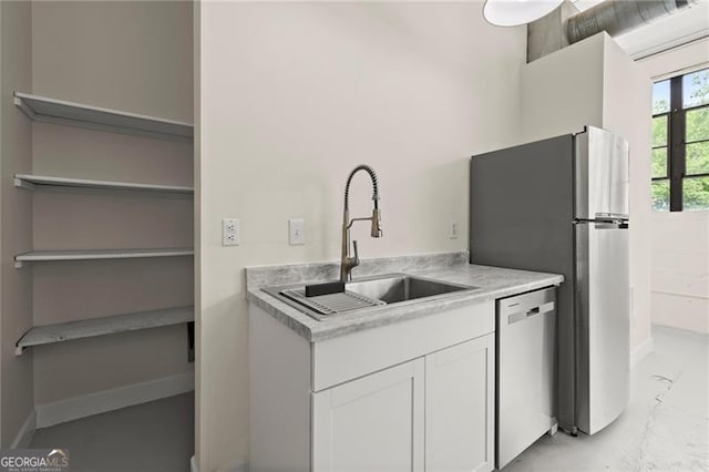 830 Dekalb Ave Unit 1, Atlanta, GA 30307 - kitchen featuring white cabinets, a sink, stainless steel appliances, light countertops, and marble finish floor