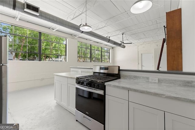 830 Dekalb Ave Unit 1, Atlanta, GA 30307 - kitchen featuring finished concrete flooring, white cabinets, visible vents, gas range, and light stone countertops