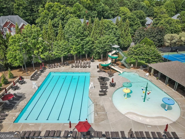 community pool featuring a water slide