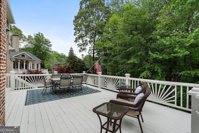 wooden deck featuring outdoor dining area