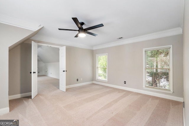 additional living space with light carpet, ceiling fan, baseboards, and vaulted ceiling
