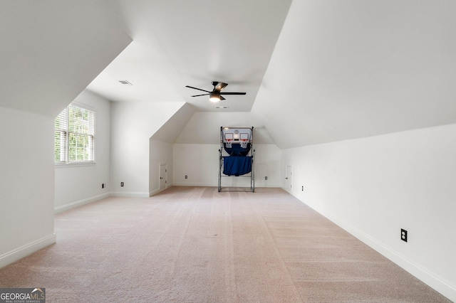 additional living space with ceiling fan, vaulted ceiling, carpet, and baseboards