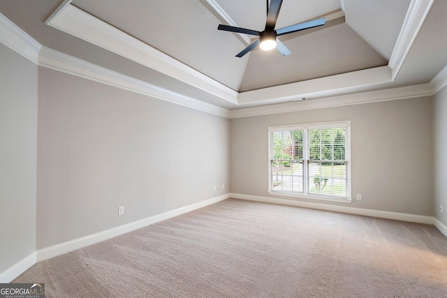 unfurnished room with a tray ceiling, a ceiling fan, carpet, ornamental molding, and baseboards