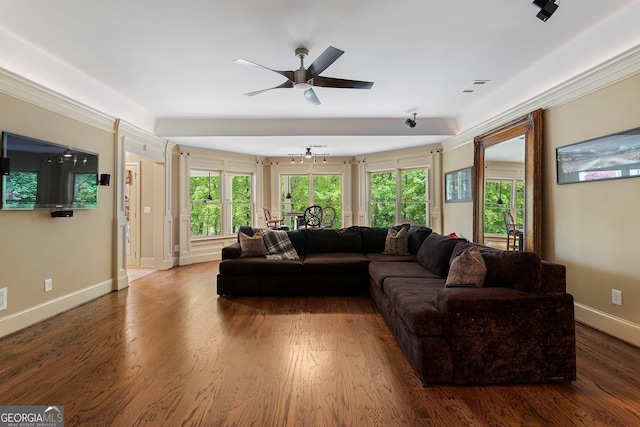 living area featuring baseboards, a ceiling fan, and wood finished floors