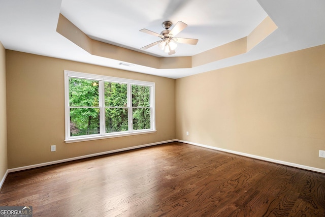 unfurnished room with wood finished floors, ceiling fan, and baseboards