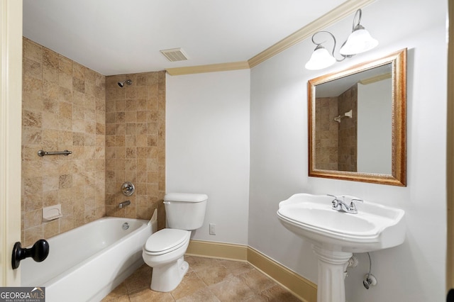 bathroom featuring toilet, baseboards, washtub / shower combination, and crown molding