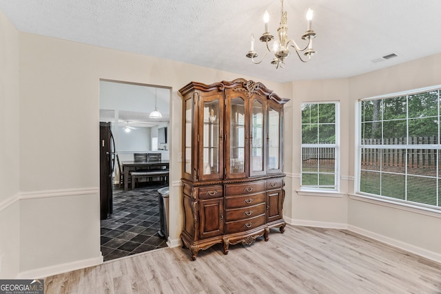 675 Michael Cir, Monroe, GA 30655 - interior space with wood finished floors, a chandelier, and baseboards