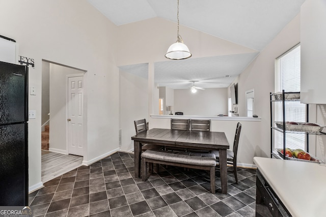 675 Michael Cir, Monroe, GA 30655 - dining space with high vaulted ceiling, dark tile patterned flooring, stairway, and baseboards